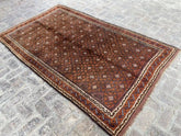 Lovely 9 x 13.1 ft Belouch hand-woven carpet in earthy tones with geometric motifs.