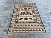 "Handwoven Afghan Soumak Kilim rug with a beige background, brown animal patterns, and geometric motifs, measuring 4'3" x 6'3"