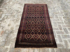 Afghan handmade rug with geometric patterns in red, brown, black, and beige, 3.6 x 6.8 feet.