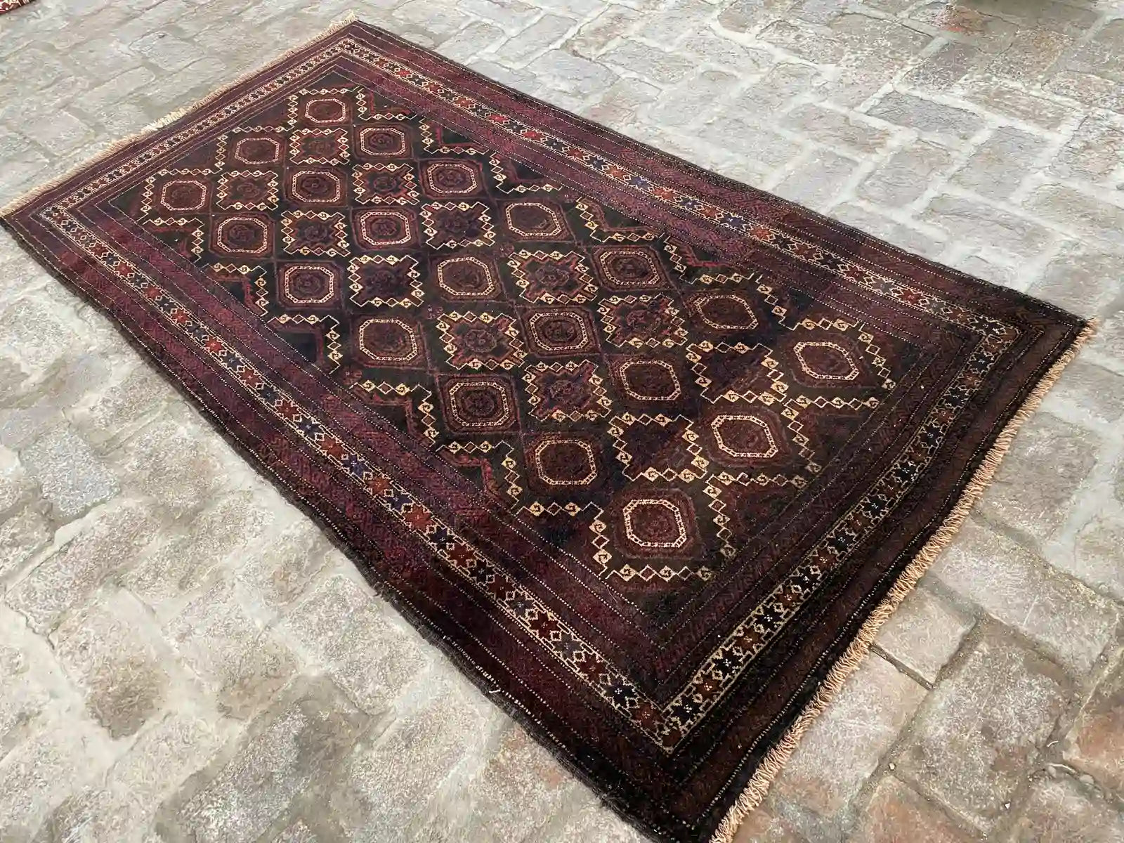 Afghan handmade rug with geometric patterns in red, brown, black, and beige, 3.6 x 6.8 feet.