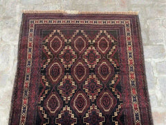 Afghan handmade rug with geometric patterns in red, brown, black, and beige, 3.6 x 6.8 feet.