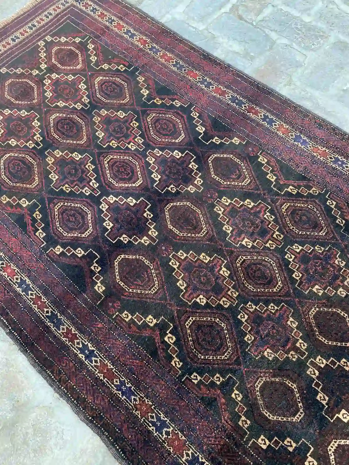 Afghan handmade rug with geometric patterns in red, brown, black, and beige, 3.6 x 6.8 feet.