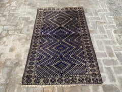 Afghan handmade rug with geometric patterns in blue, beige, and black, 3.8 x 6.0 feet.