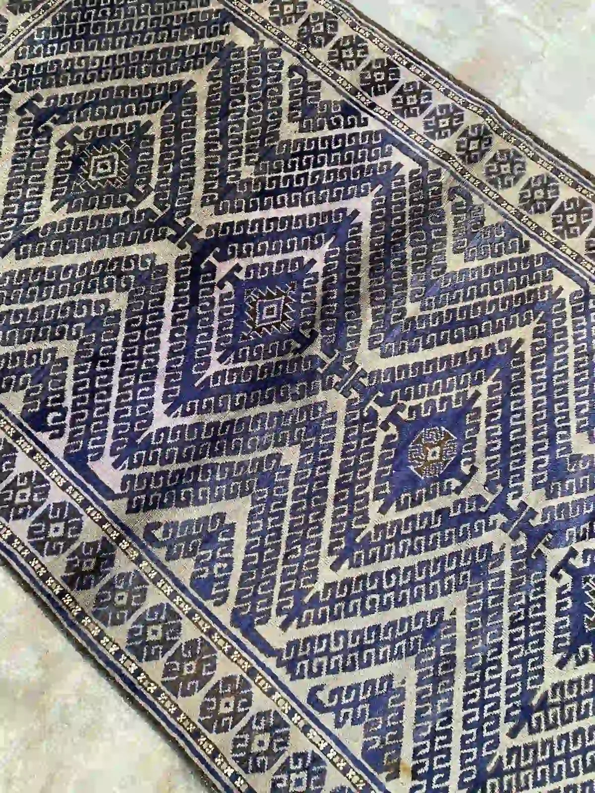 Afghan handmade rug with geometric patterns in blue, beige, and black, 3.8 x 6.0 feet.