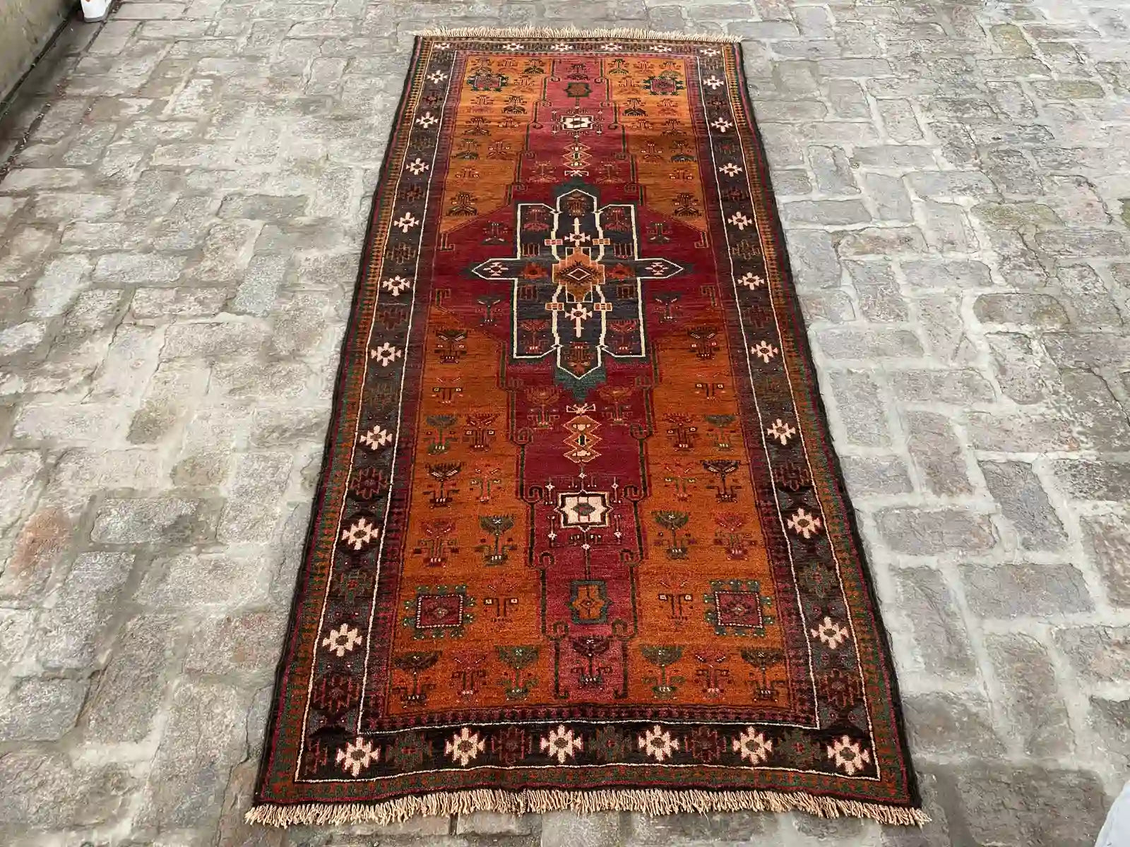 Afghan handmade Baluch rug with geometric patterns in red, orange, green, and black, 3.8 x 8.6 feet.