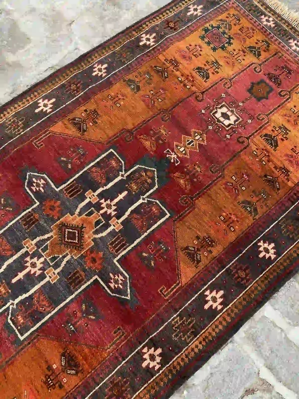 Afghan handmade Baluch rug with geometric patterns in red, orange, green, and black, 3.8 x 8.6 feet.