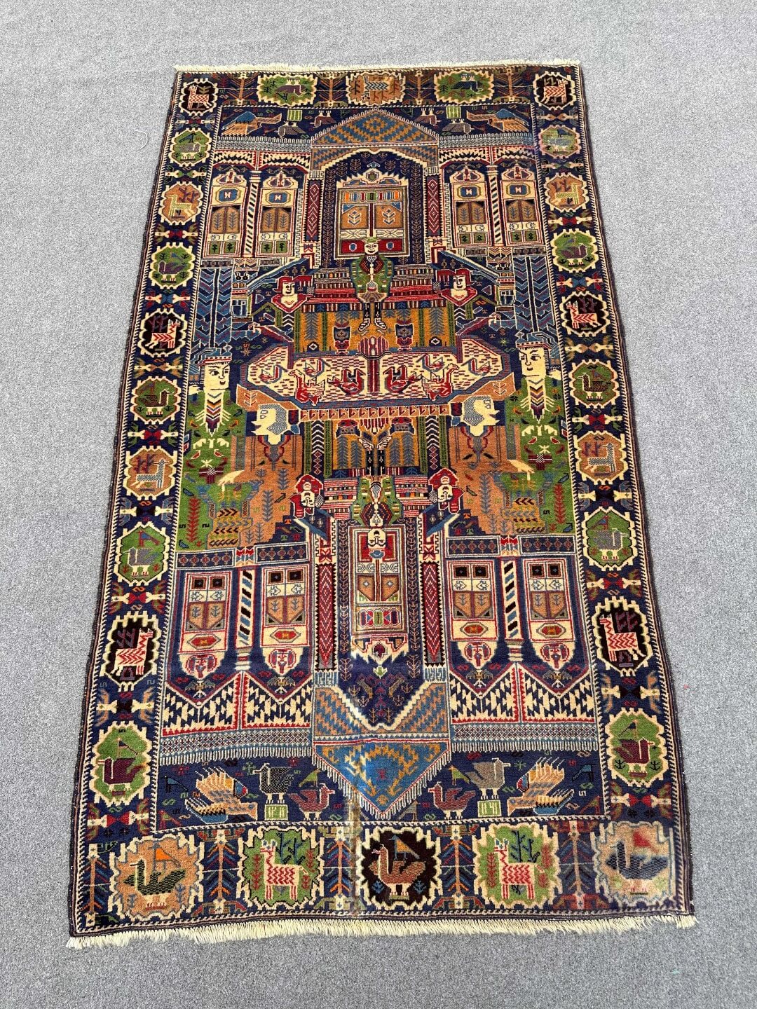 Pictorial hand knotted tribal wool rug