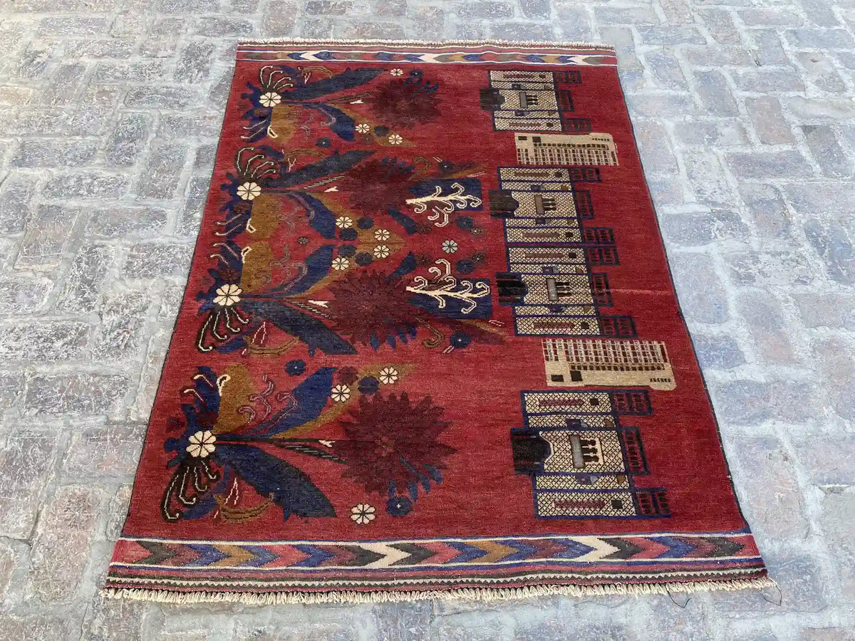 Hand-knotted Afghan Belouch rug with rich red background, floral, and architectural motifs, measuring 4'2" x 6'0