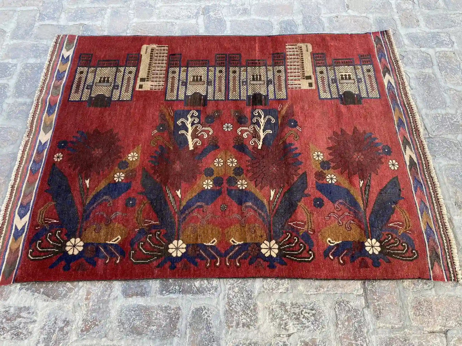 Hand-knotted Afghan Belouch rug with rich red background, floral, and architectural motifs, measuring 4'2" x 6'0