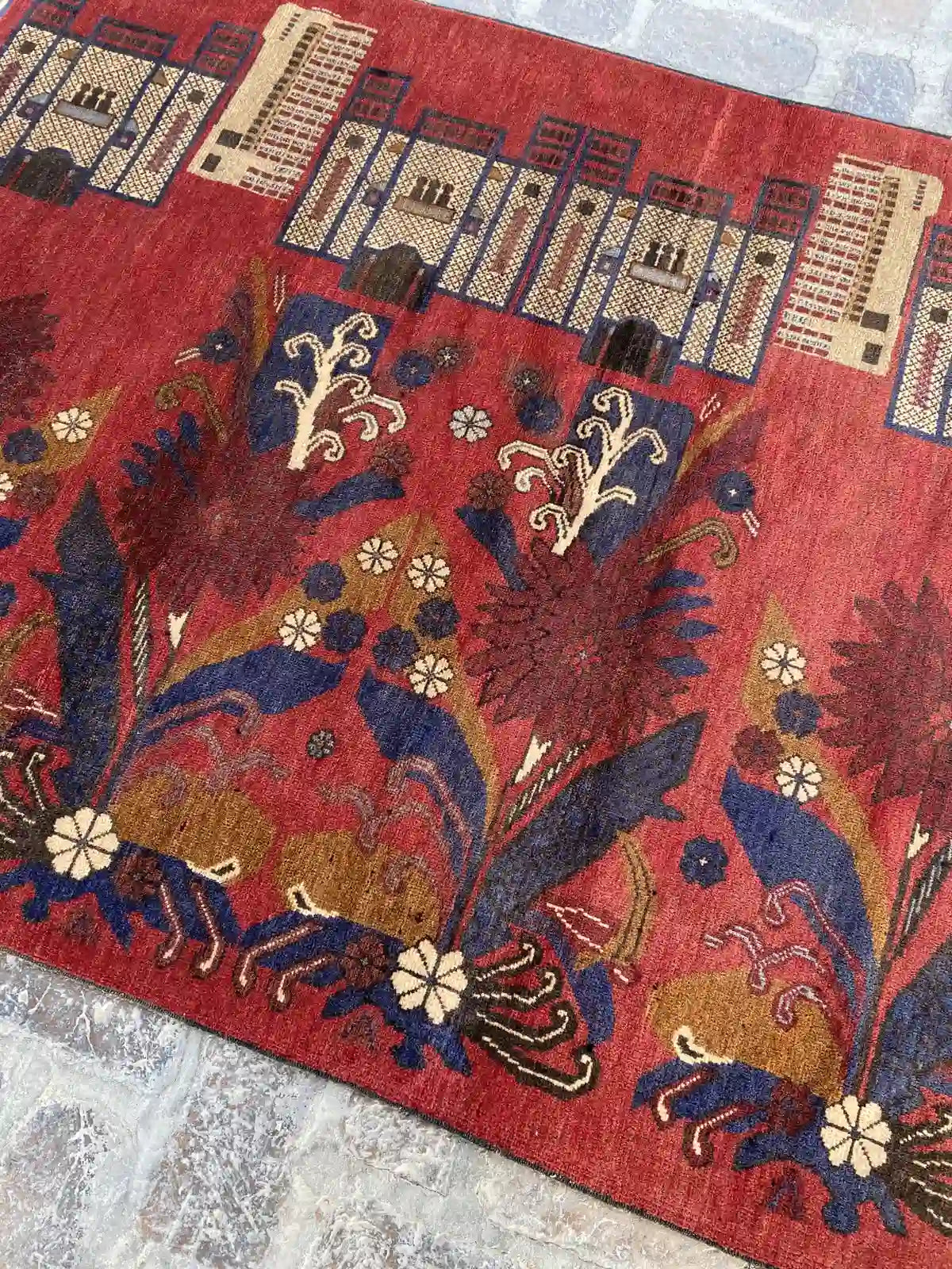 Hand-knotted Afghan Belouch rug with rich red background, floral, and architectural motifs, measuring 4'2" x 6'0