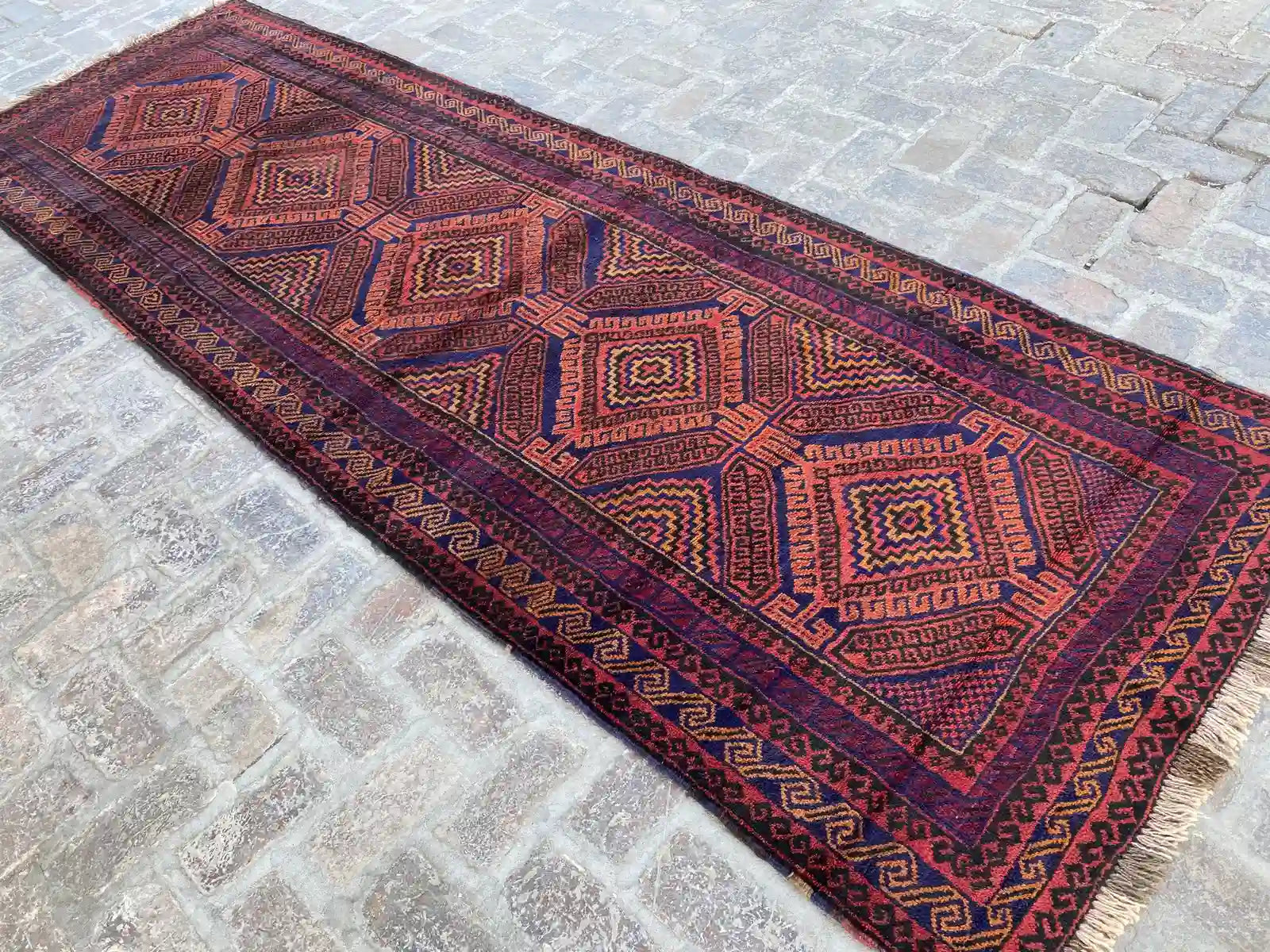 Hand-knotted Afghan Belouchi rug runner with geometric diamond patterns in red and blue, measuring 4'0" x 11'10", vintage from 2000