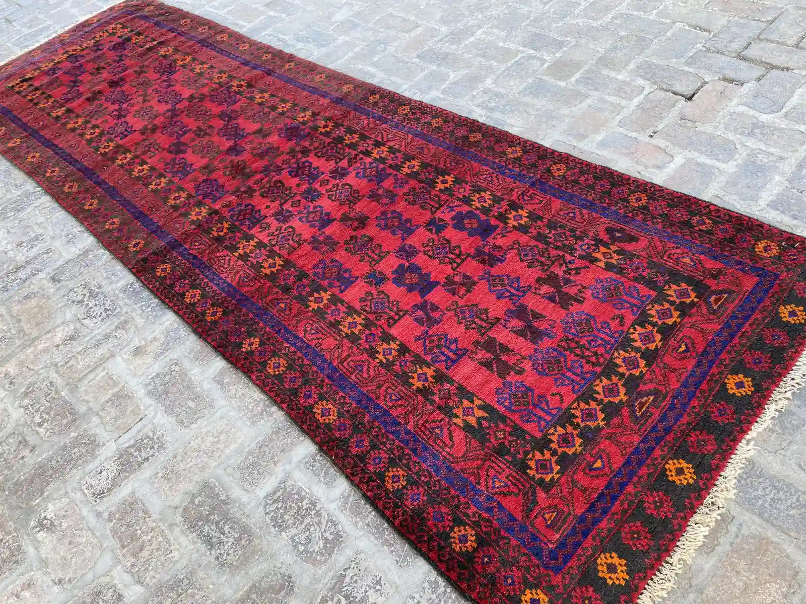 Hand-knotted Afghan Belouchi rug runner with vibrant red background, blue, and orange geometric patterns, measuring 4'0" x 12'2