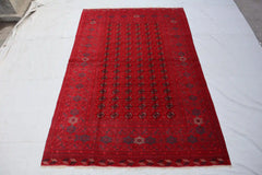 Afghan Bokhara handmade rug with intricate geometric patterns in red, black, and beige, 6.5 x 9.0 feet.