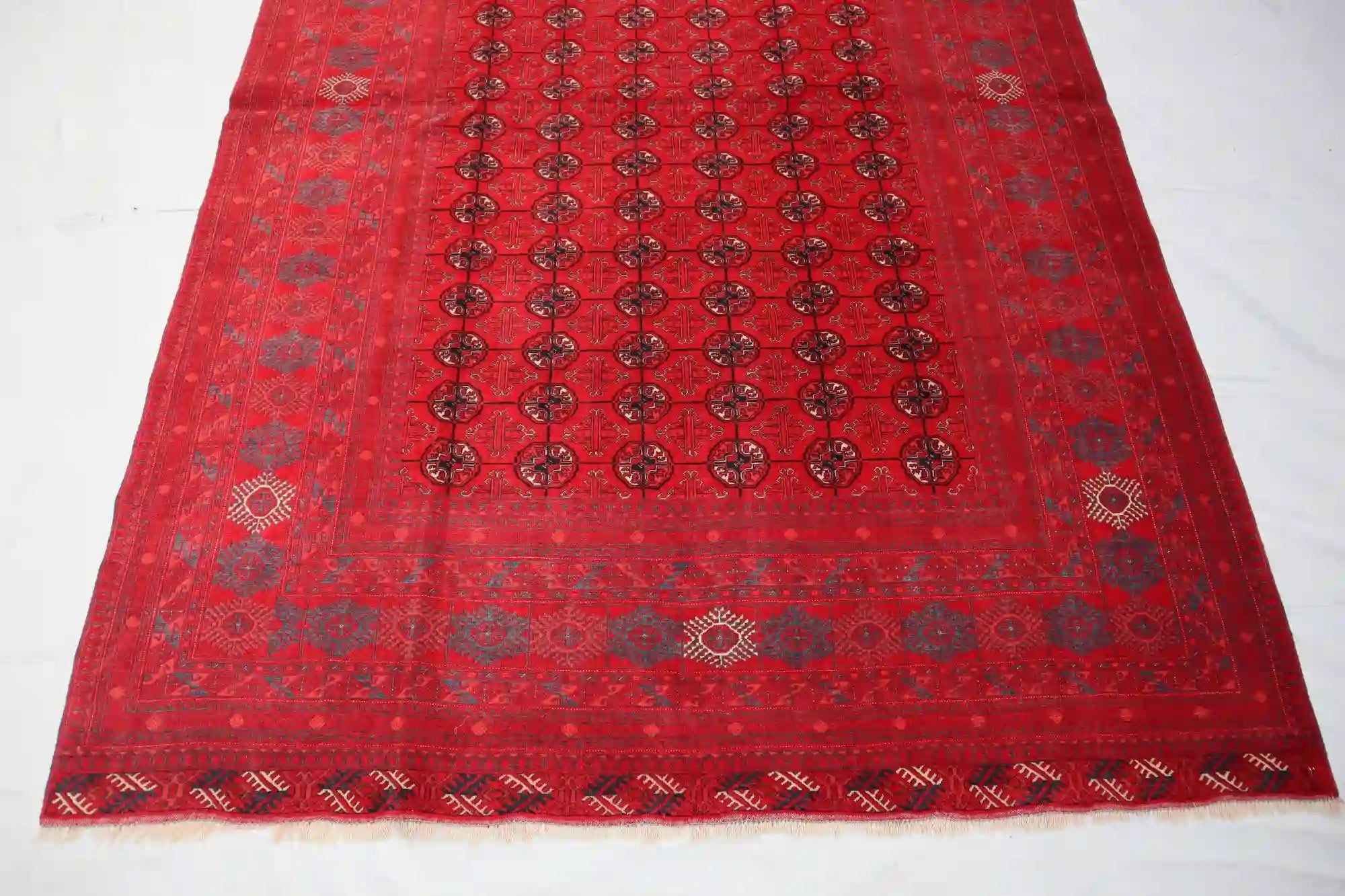 Afghan Bokhara handmade rug with intricate geometric patterns in red, black, and beige, 6.5 x 9.0 feet.