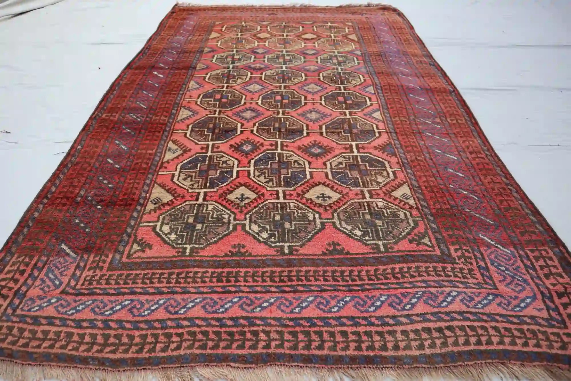 Afghan Chob Bash handmade rug with geometric patterns in red, orange, blue, and black, 4.6 x 7.0 feet.