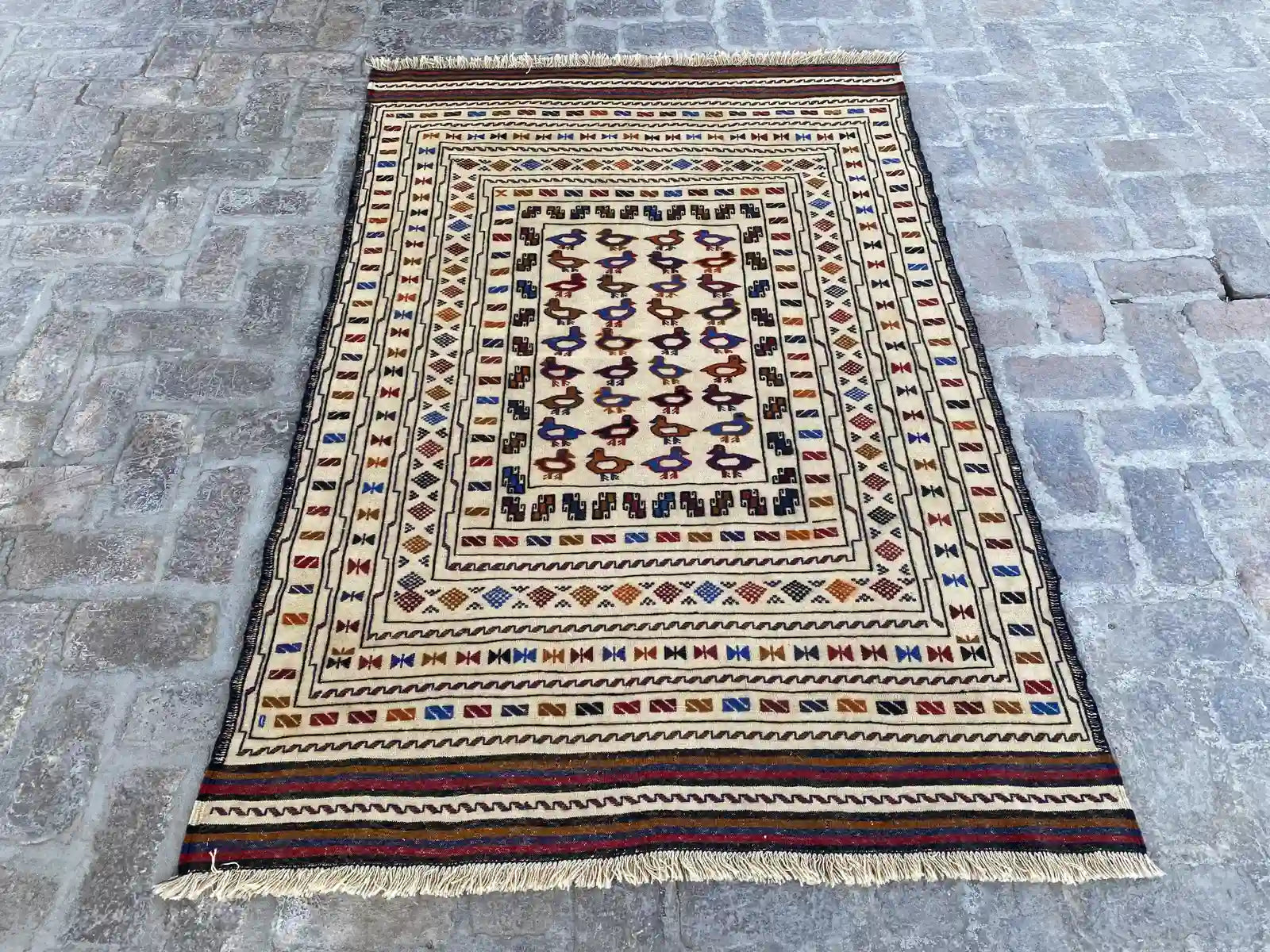 "Handwoven Afghan Soumak Kilim rug with a beige background and multicolor geometric patterns, measuring 4'4" x 6'5"